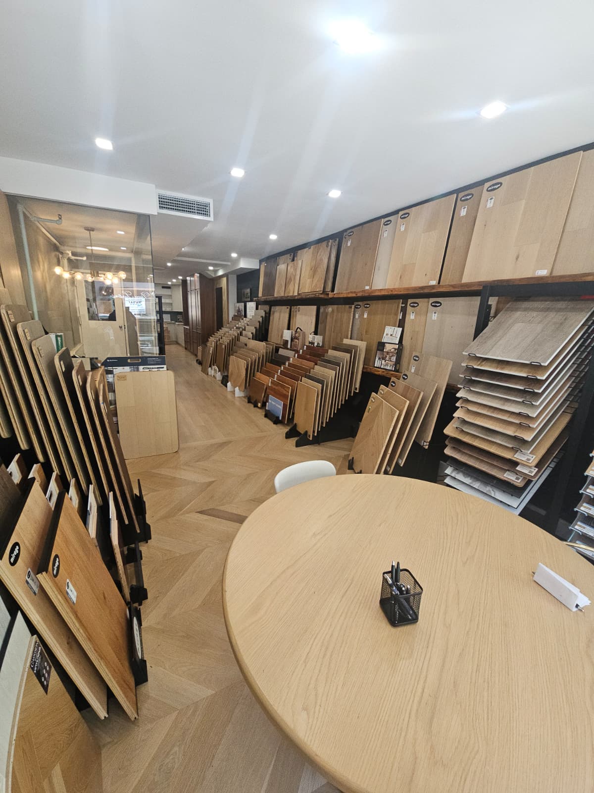 NYC Floor Pro showroom: wood floor sample displays and a consultation table