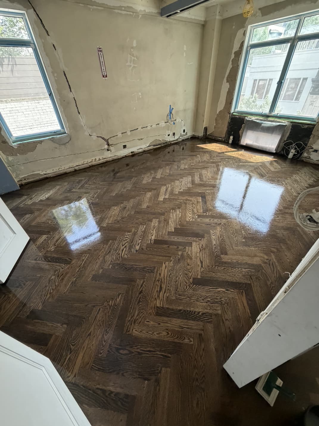 White oak herringbone floor stained dark walnut with a satin finish in an Upper East Side pre-war co-op