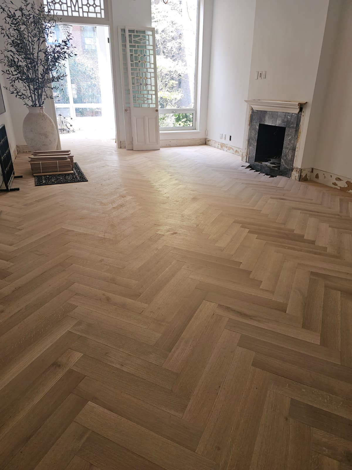 White oak herringbone across the parlor floor of an Upper West Side brownstone