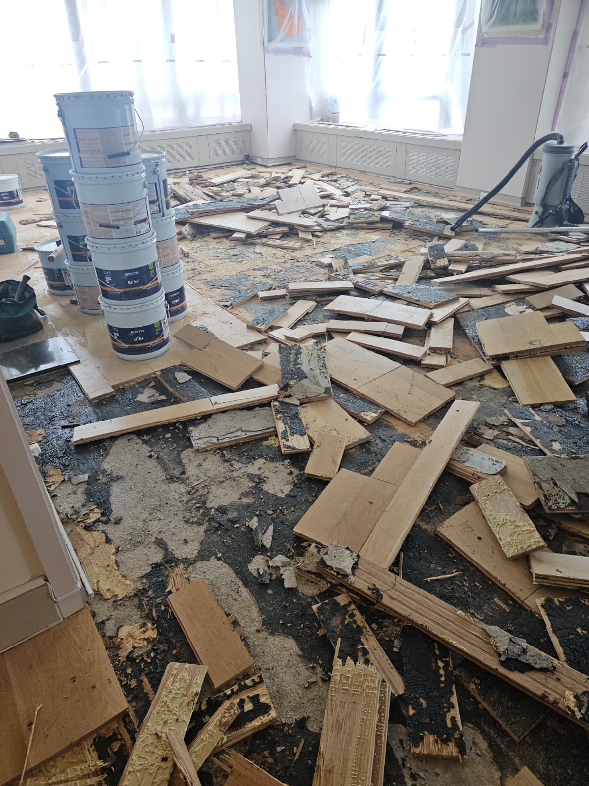 Demolition of water-damaged flooring in a Tribeca apartment