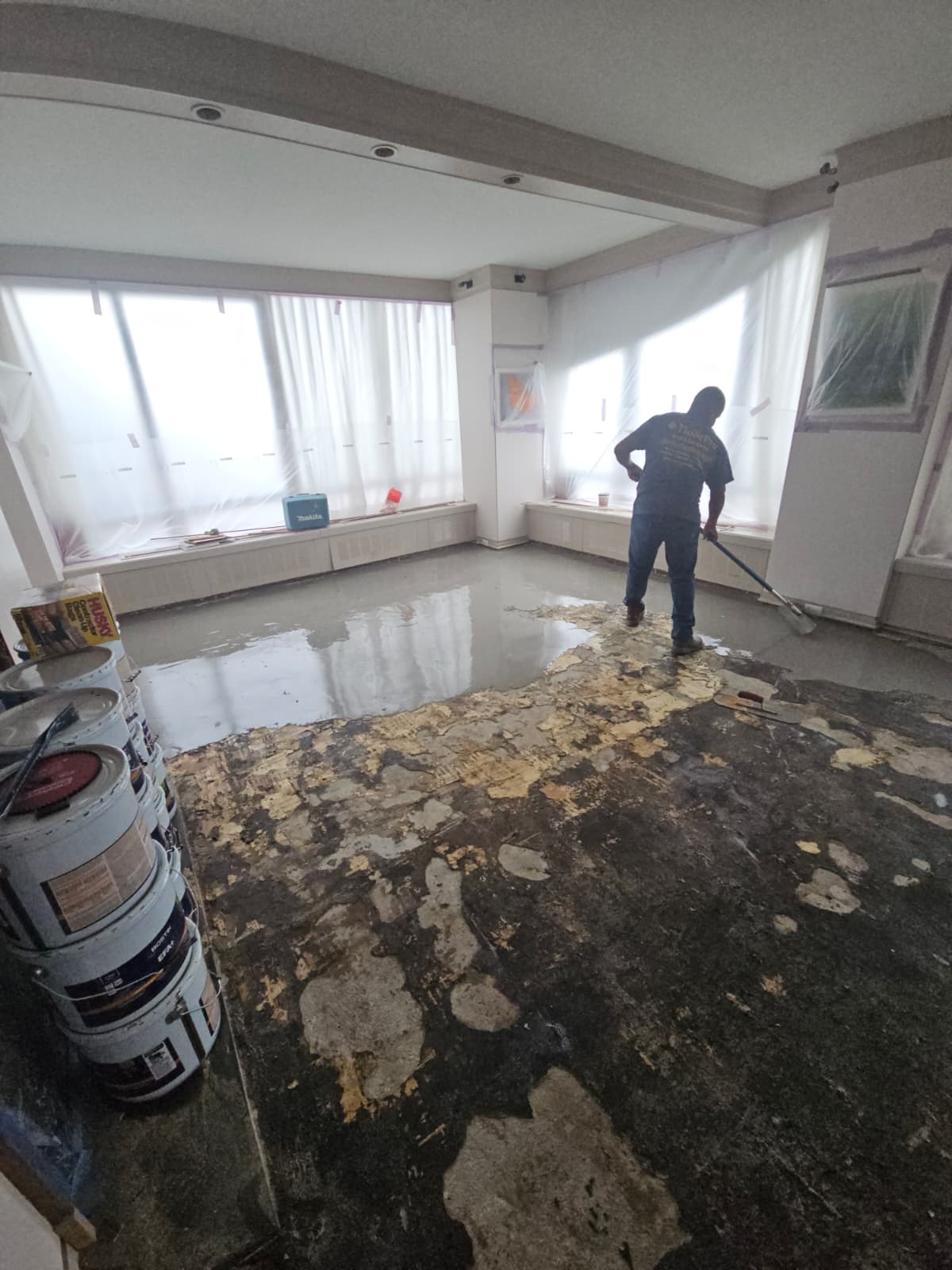 Leveling the concrete slab after the water-damaged floor was removed