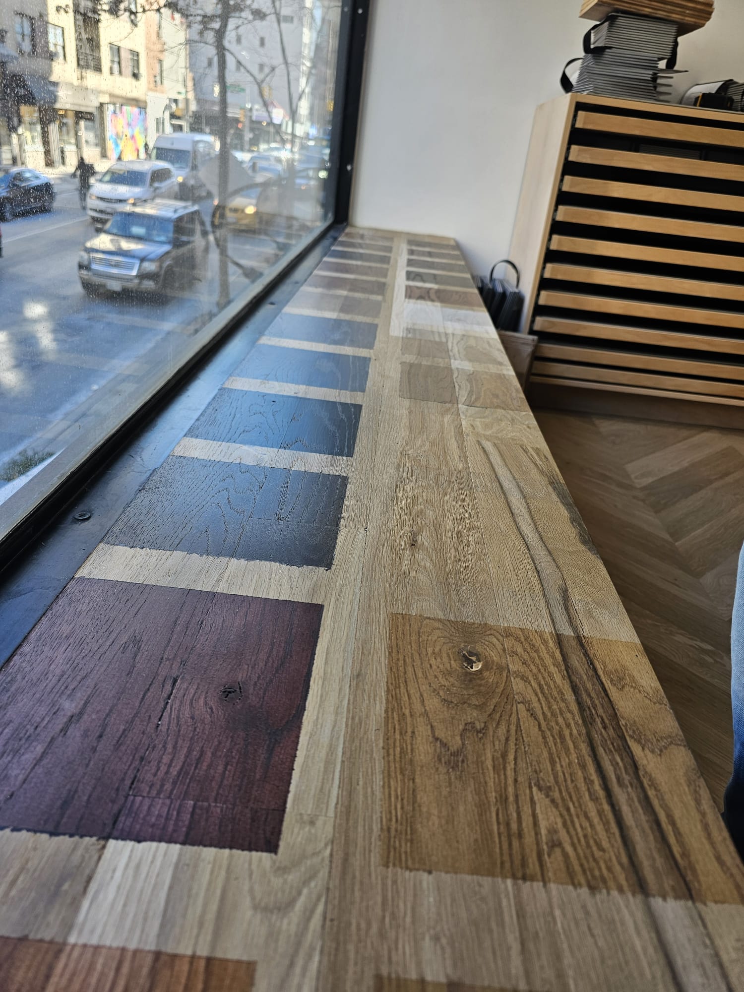 Stain sample strips on the showroom window sill