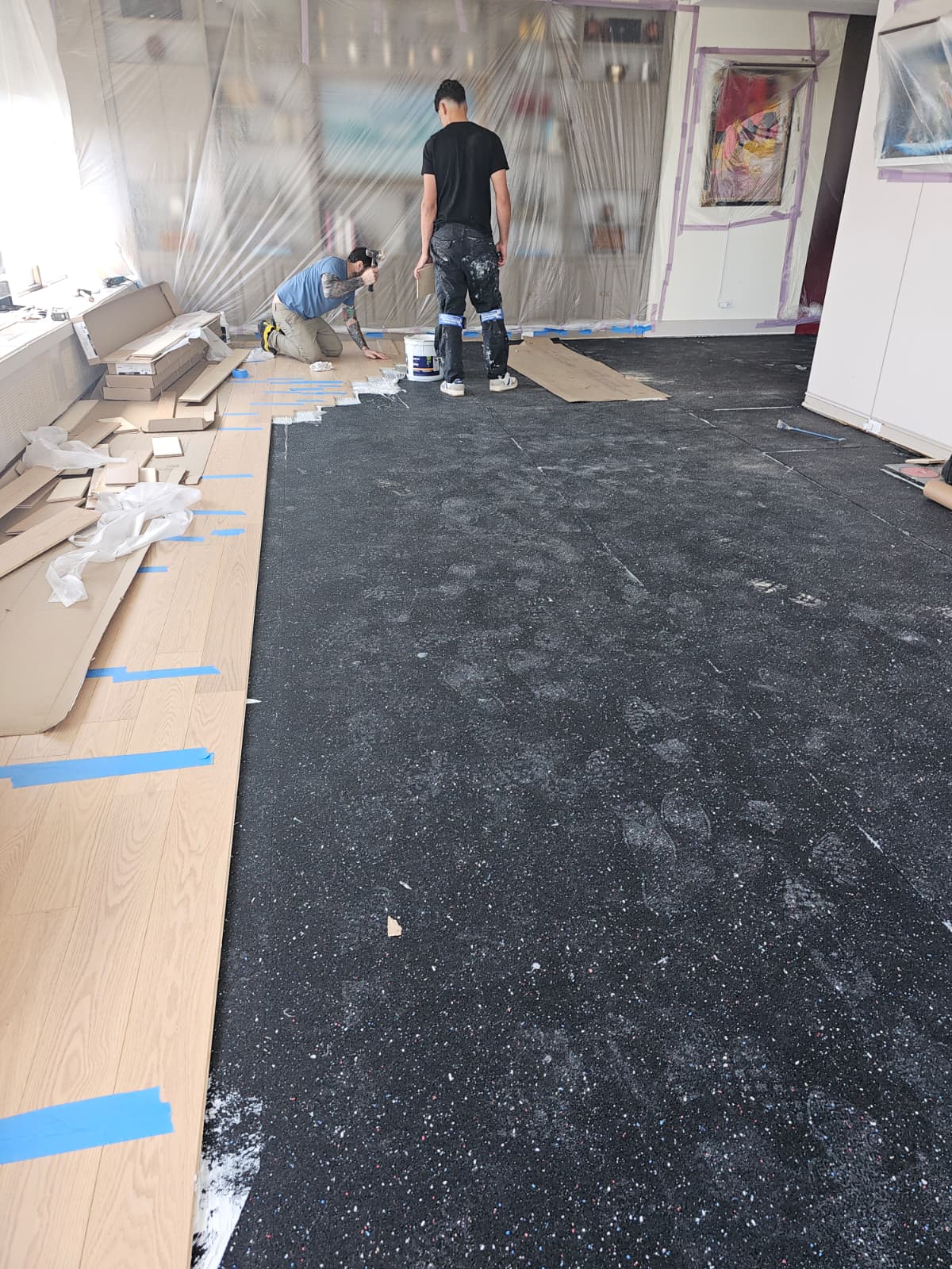 Soundproofing glued down and engineered oak plank installation in progress