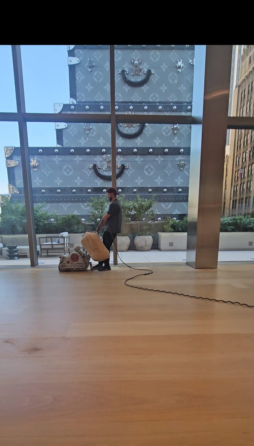 Sanding the wide plank engineered oak floor at the Tiffany flagship store in Midtown West