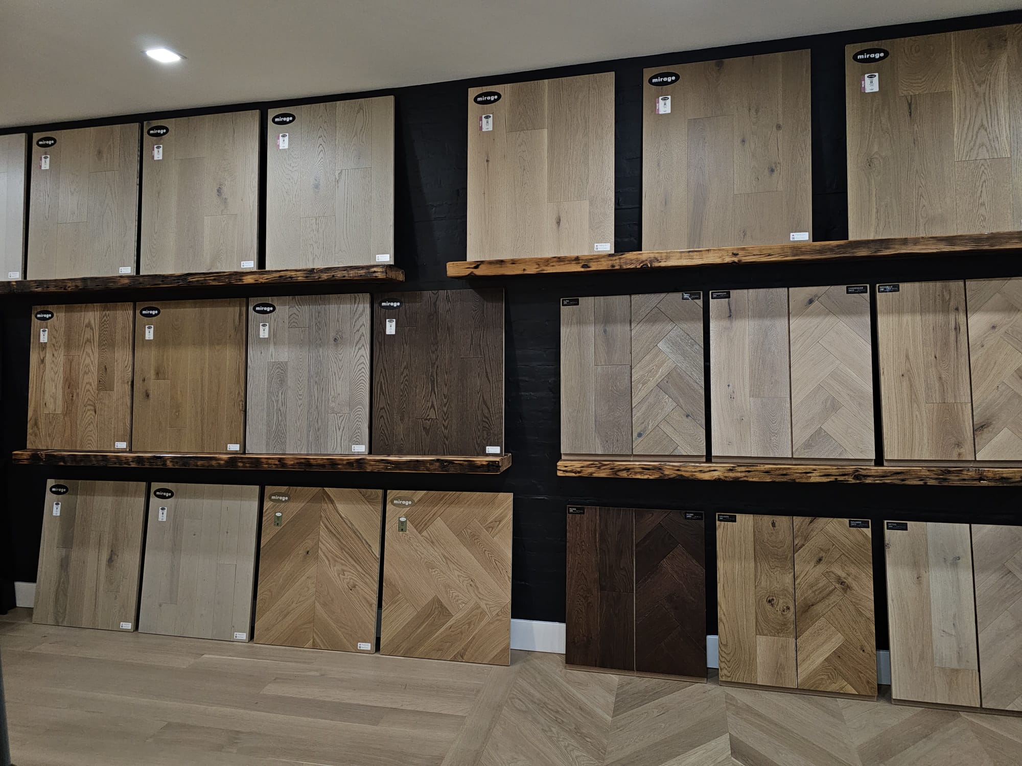 Wall of Mirage wood floor samples including herringbone and chevron patterns