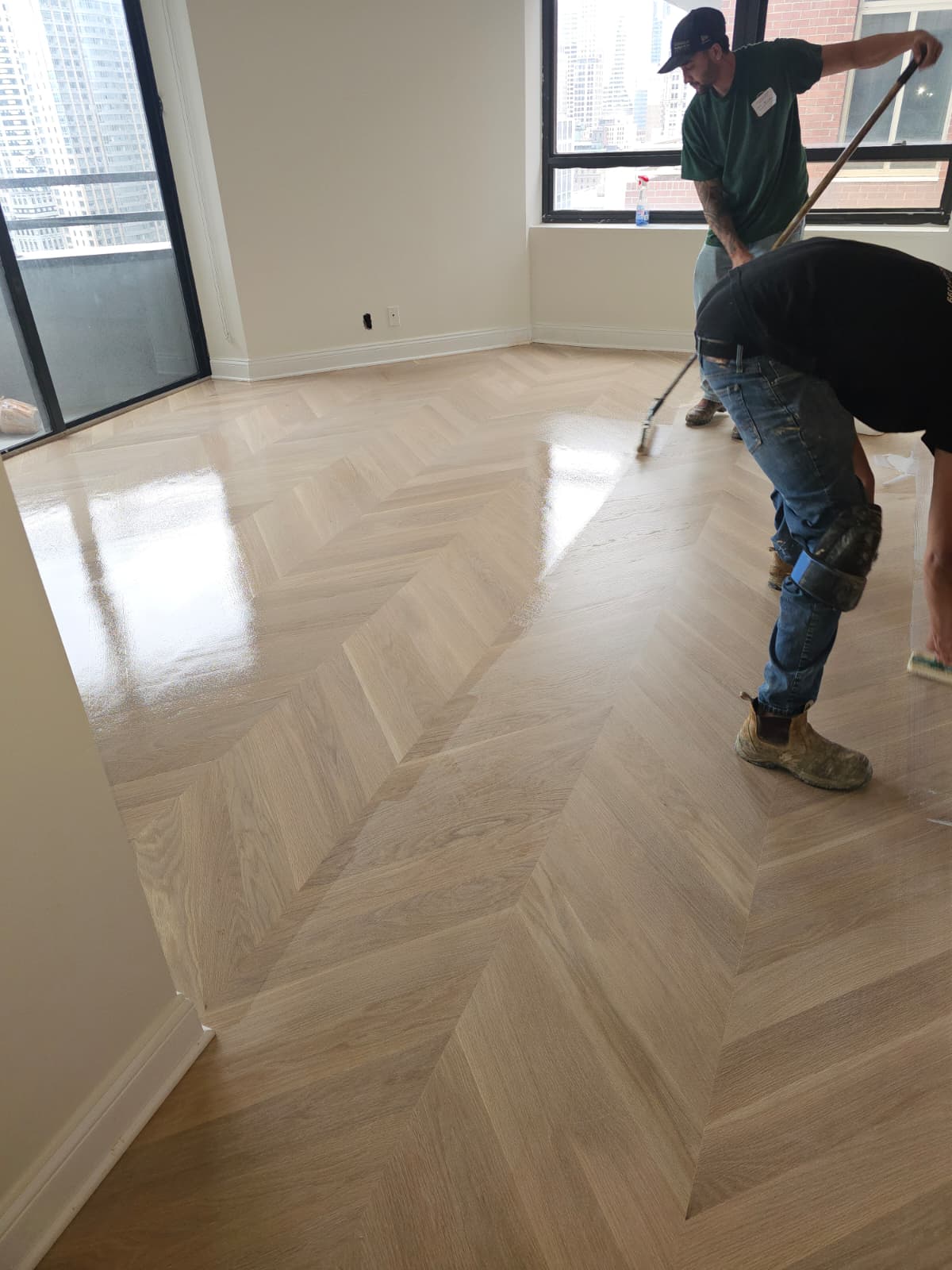 Applying Bona Nordic Seal to the sanded white oak chevron floor
